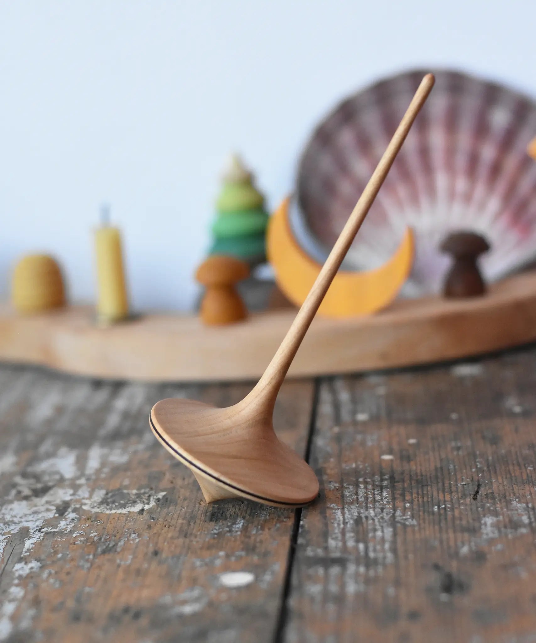 Mader trumpo spinning tops 55mm placed on a wooden surface in the Babipur playroom.