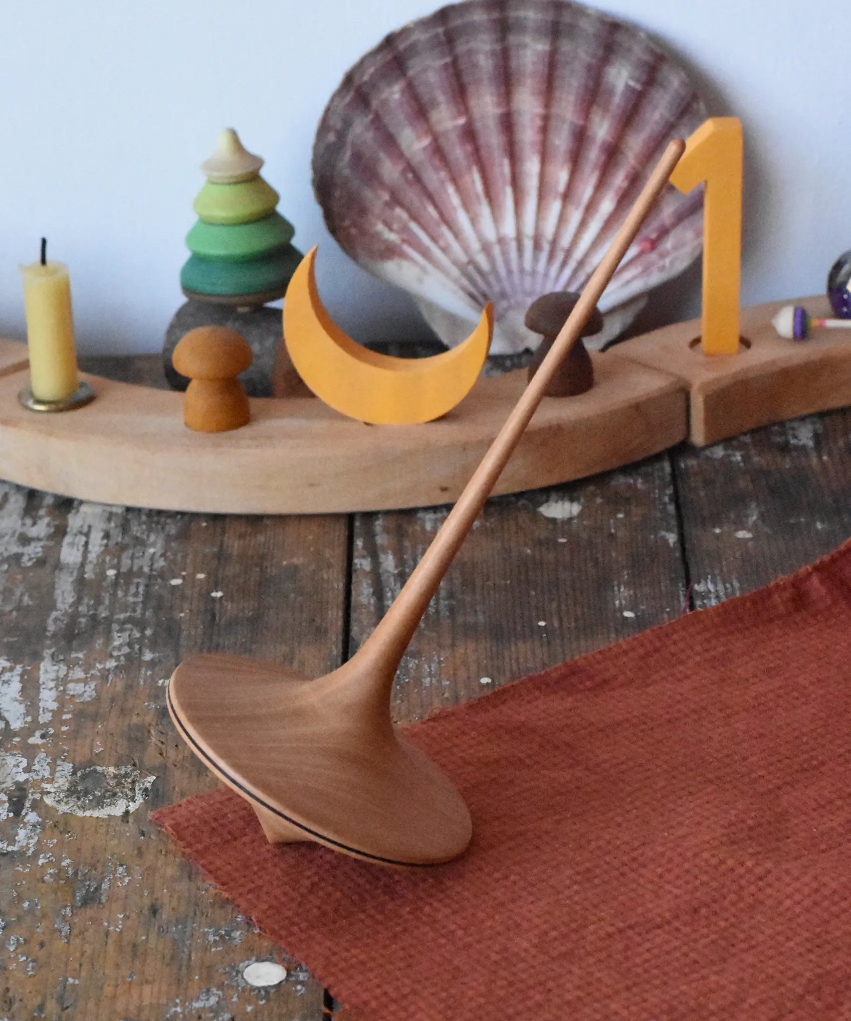 Mader trumpo spinning top 75mm placed on a wooden surface in the Babipur playroom.
