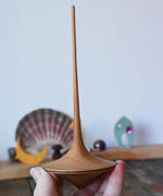 Mader trumpo spinning tops 75mm in an adult's hand.