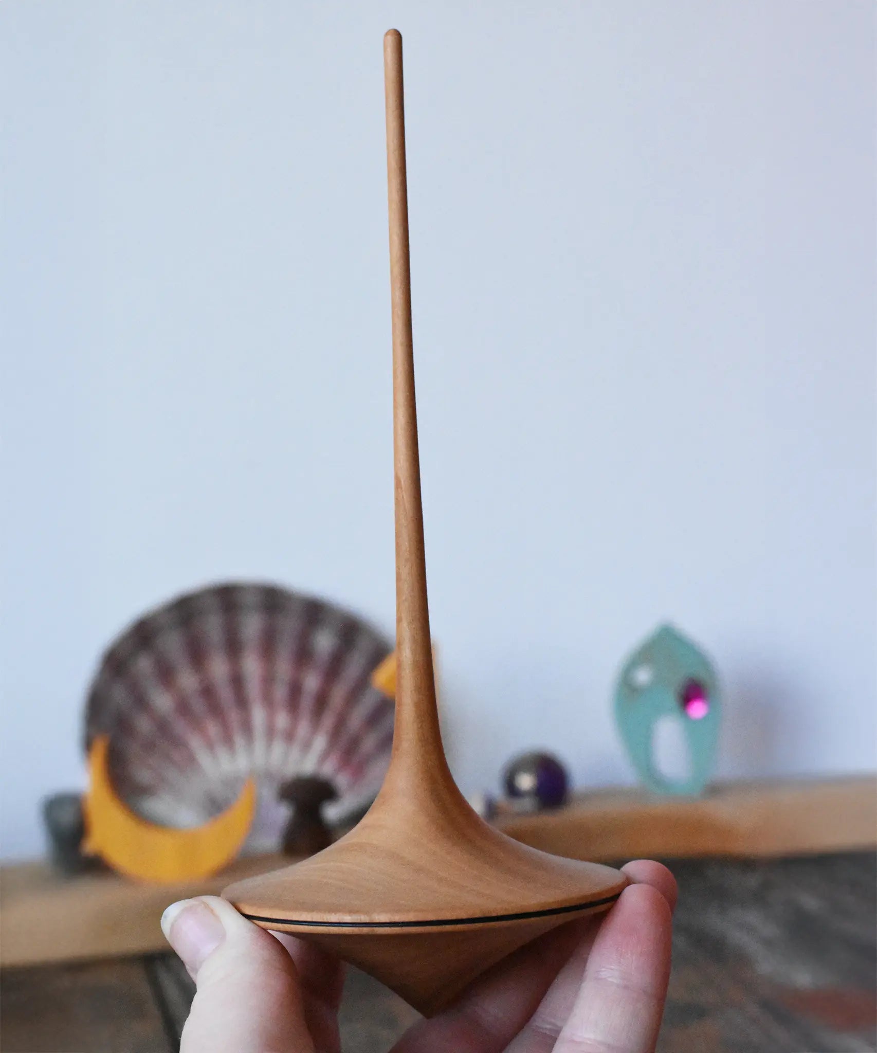 Mader trumpo spinning tops 75mm in an adult's hand.
