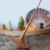 Mader trumpo spinning top 75mm placed on a wooden surface in the Babipur playroom.