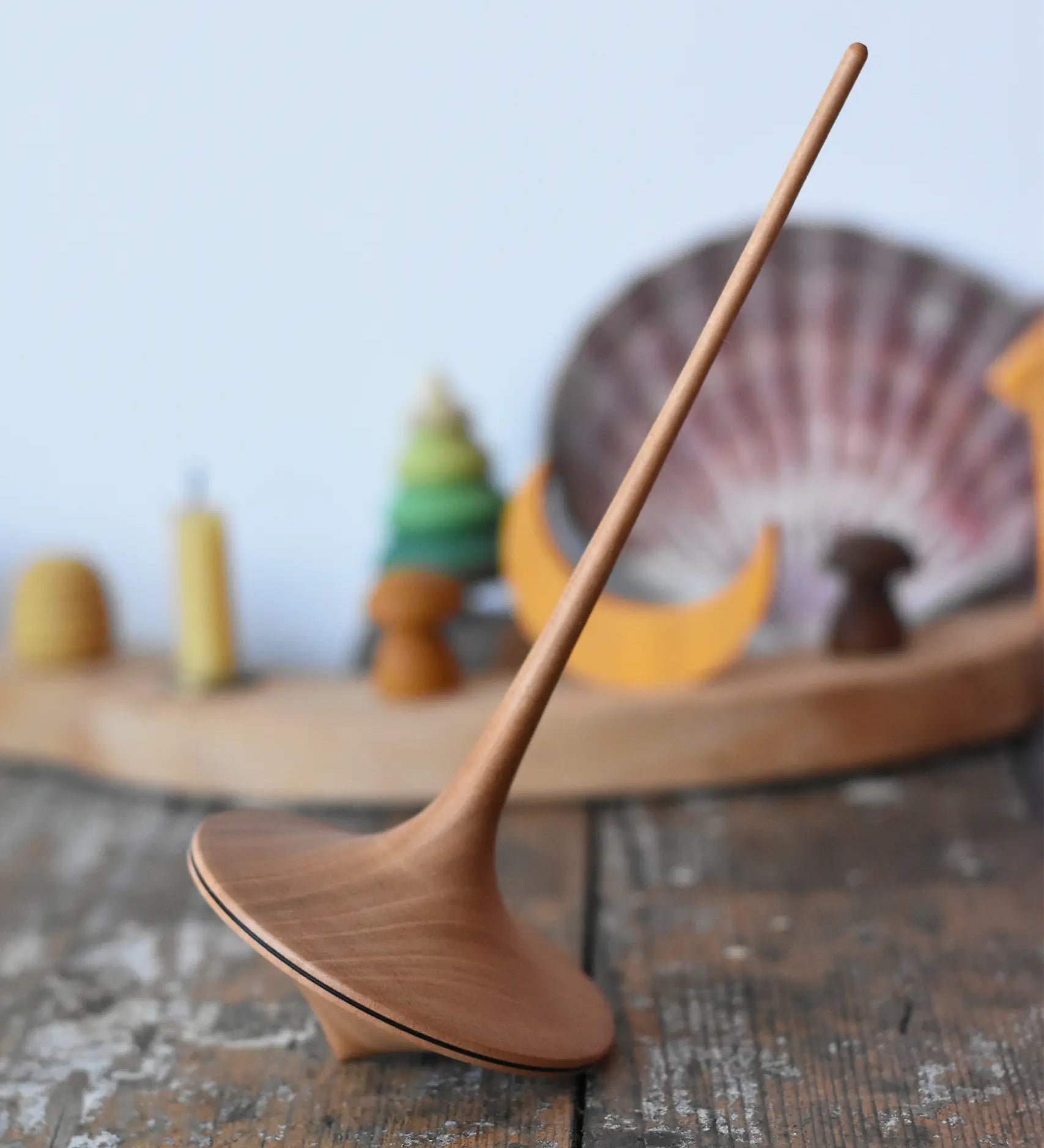 Mader trumpo spinning top 75mm placed on a wooden surface in the Babipur playroom.