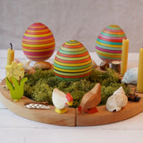 Mader wooden roly-poly wooden eggs placed in a seasonal display with a Grimm's celebration ring. 