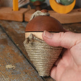 Mader natural profi throw spinning top in an adult hand.