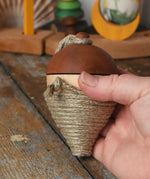 Mader natural profi throw spinning top in an adult hand.