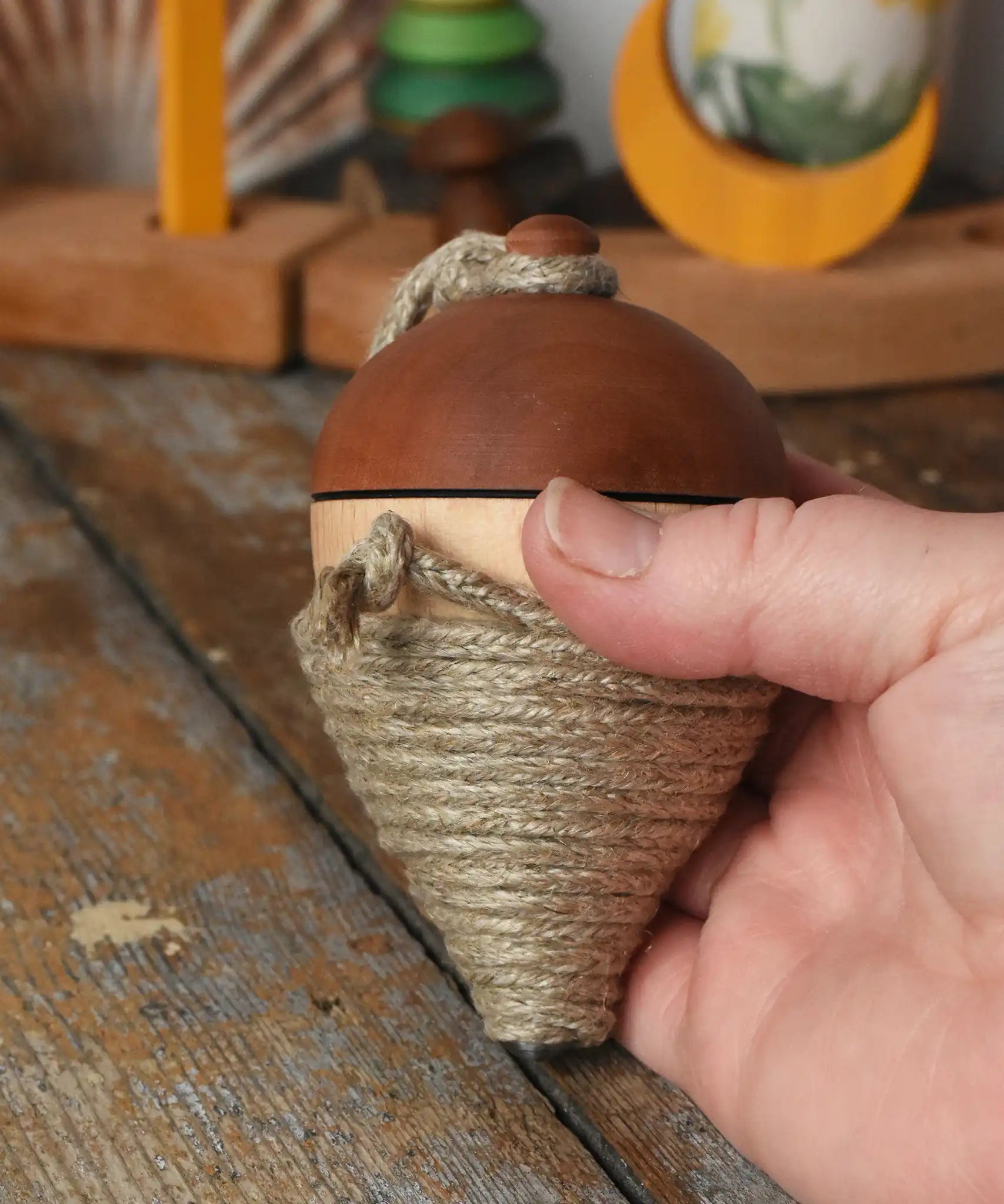 Mader natural profi throw spinning top in an adult hand.