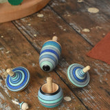Mader Kreiselmanufaktur ice blue spinning top learning set on a wooden surface in the Babipur playroom. 