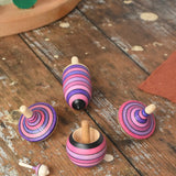Mader lilac purple spinning top learning set placed on a wooden surface in the Babipur playroom. 