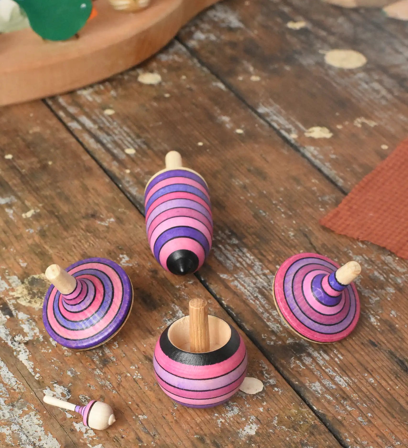 Mader lilac purple spinning top learning set placed on a wooden surface in the Babipur playroom. 