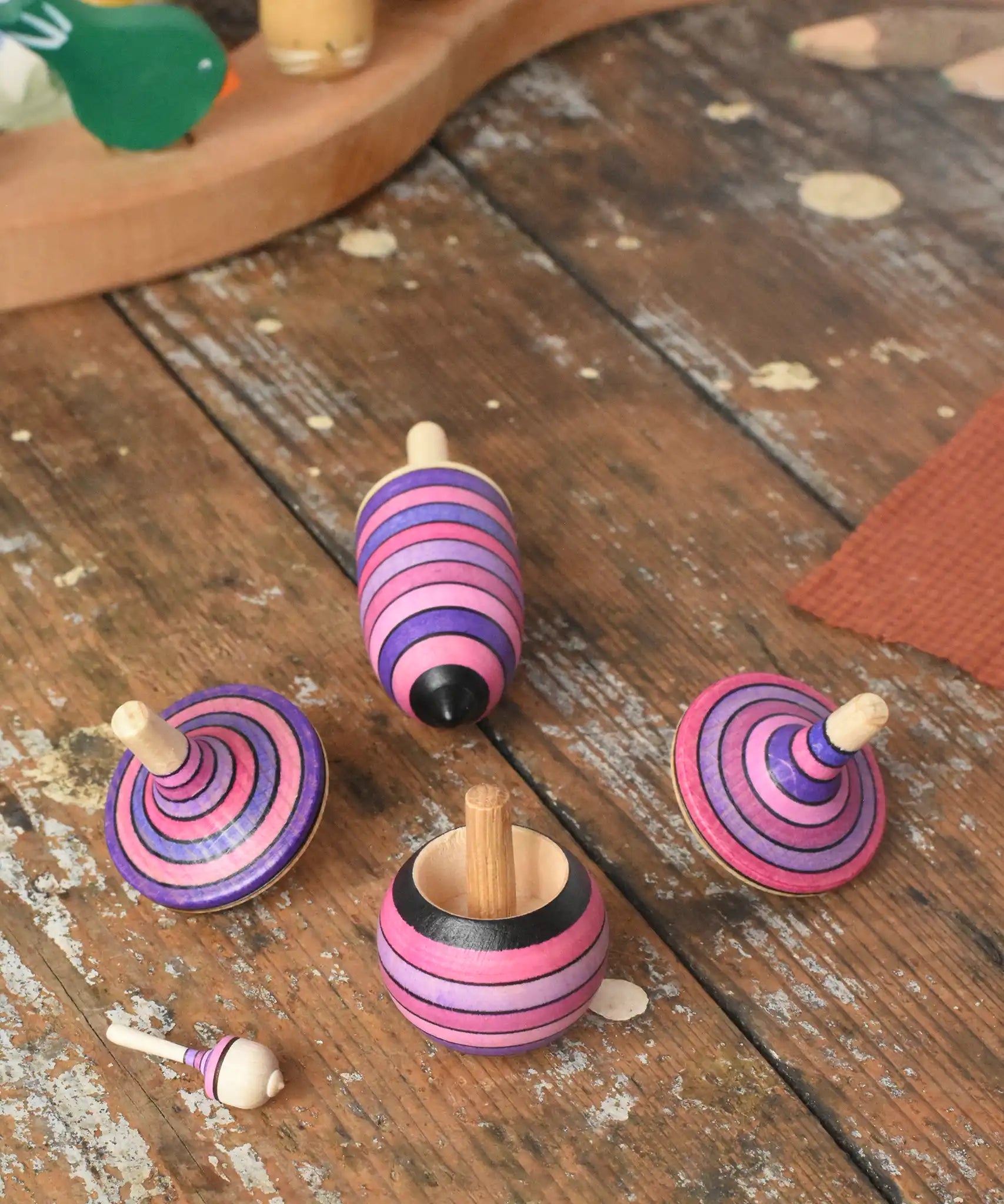Mader lilac purple spinning top learning set placed on a wooden surface in the Babipur playroom. 
