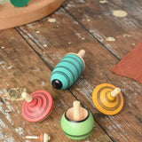 Mader Kreiselmanufaktur multicolour spinning top learning set placed on a wooden surface in the Babipur playroom. 