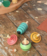 Mader Kreiselmanufaktur multicolour spinning top learning set placed on a wooden surface in the Babipur playroom. 