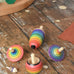 Mader Kreiselmanufaktur rainbow spinning top learning set placed on a wooden surface in the Babipur playroom. 