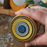 Mader Kreiselmanufaktur yoyo harlequin in an adult's hand.
