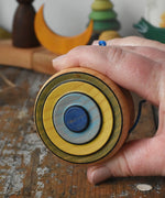 Mader Kreiselmanufaktur yoyo harlequin in an adult's hand.