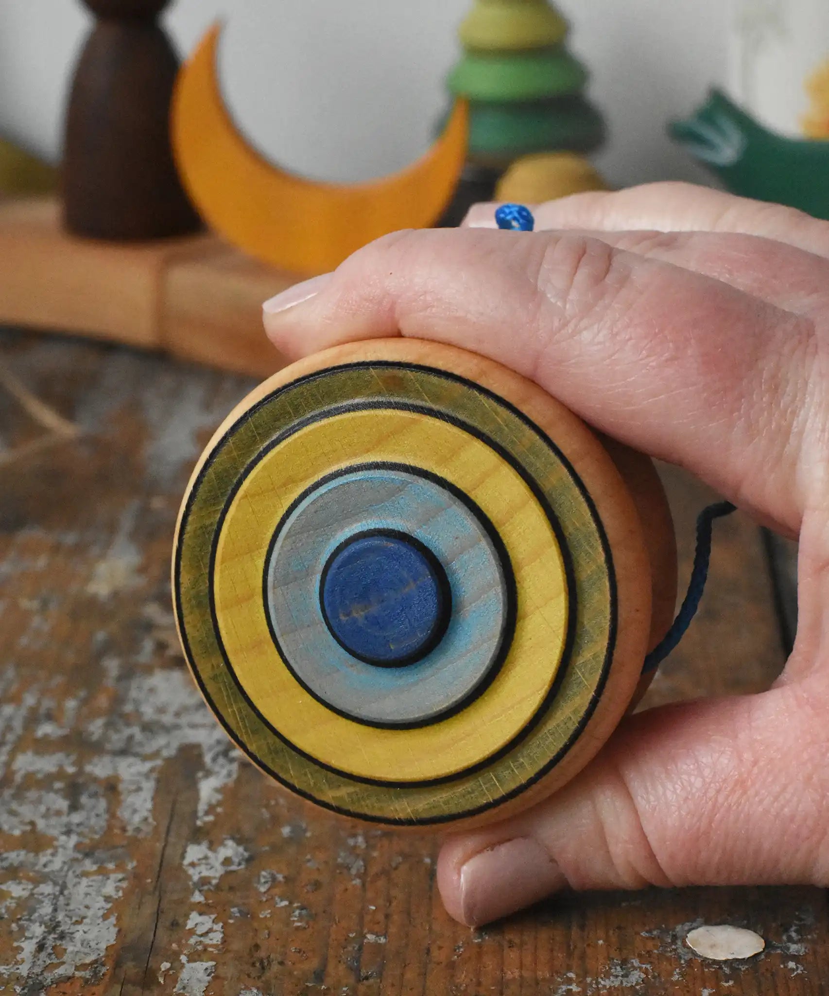 Mader Kreiselmanufaktur yoyo harlequin in an adult's hand.