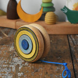Mader Kreiselmanufaktur yoyo harlequin placed on a wooden desk in the Babipur playroom.