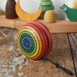 Mader yoyo rainbow placed on a wooden desk in the Babipur playroom.