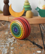 Mader yoyo rainbow placed on a wooden desk in the Babipur playroom.