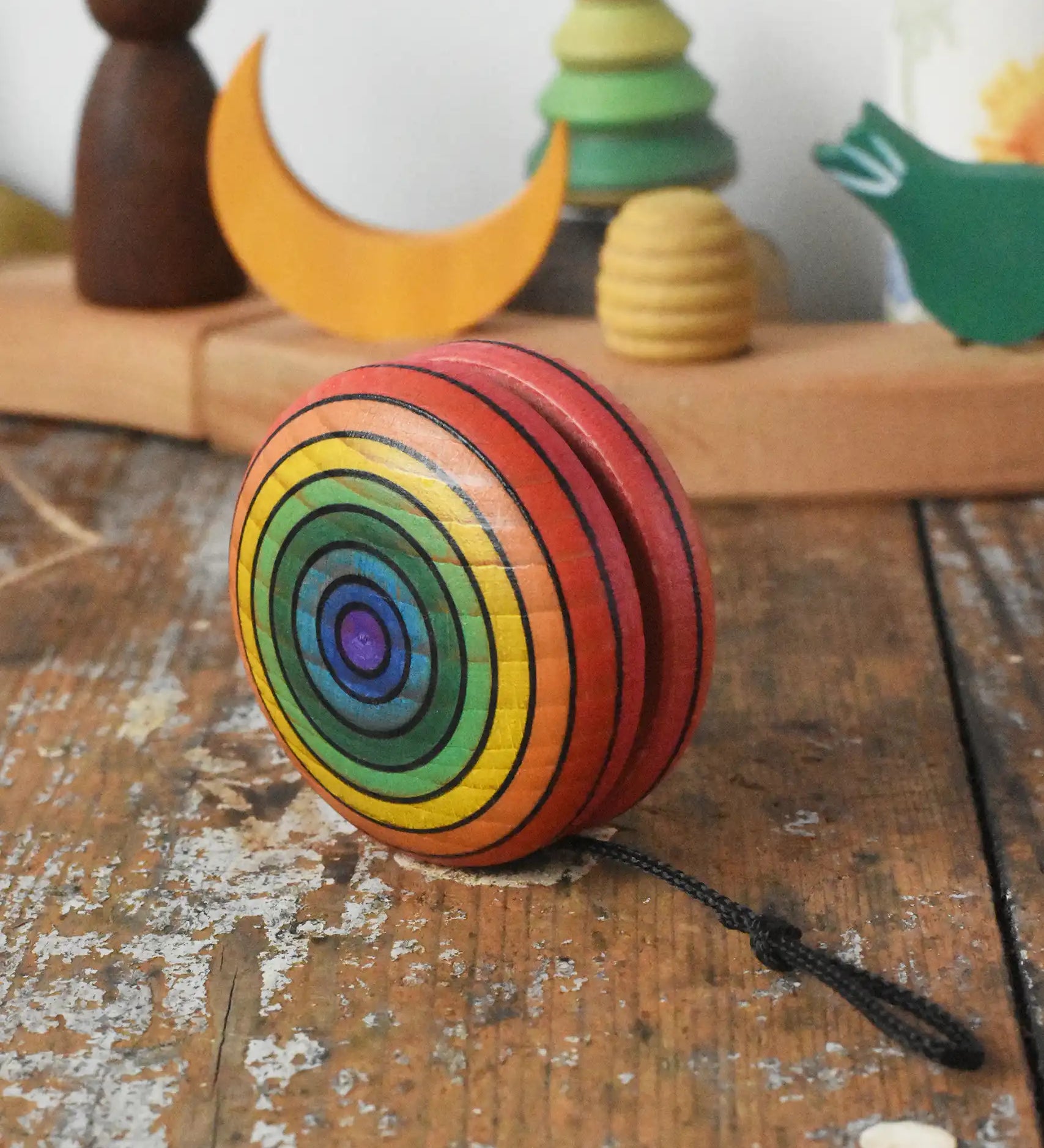 Mader yoyo rainbow placed on a wooden desk in the Babipur playroom.