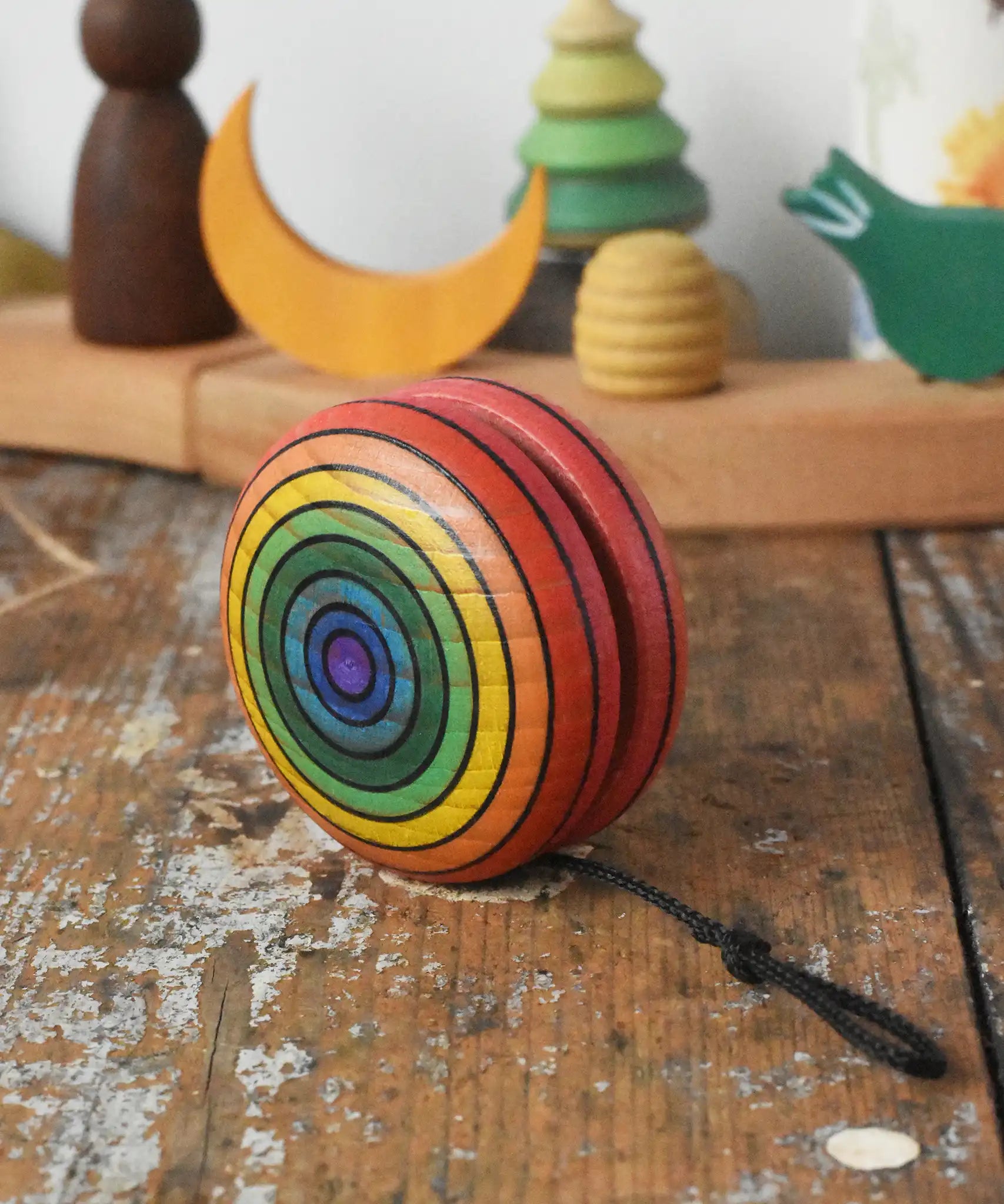 Mader yoyo rainbow placed on a wooden desk in the Babipur playroom.