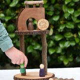 Child placing a Nin on s structure created using pieces from the Magic Wood Eco Blocks Big Box 70 piece set .