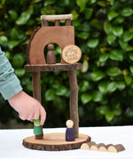 Child placing a Nin on s structure created using pieces from the Magic Wood Eco Blocks Big Box 70 piece set .