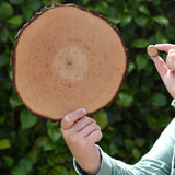 Child holding the largest and smallest piece from the Magic Wood Eco Blocks Big Box 70 piece set.