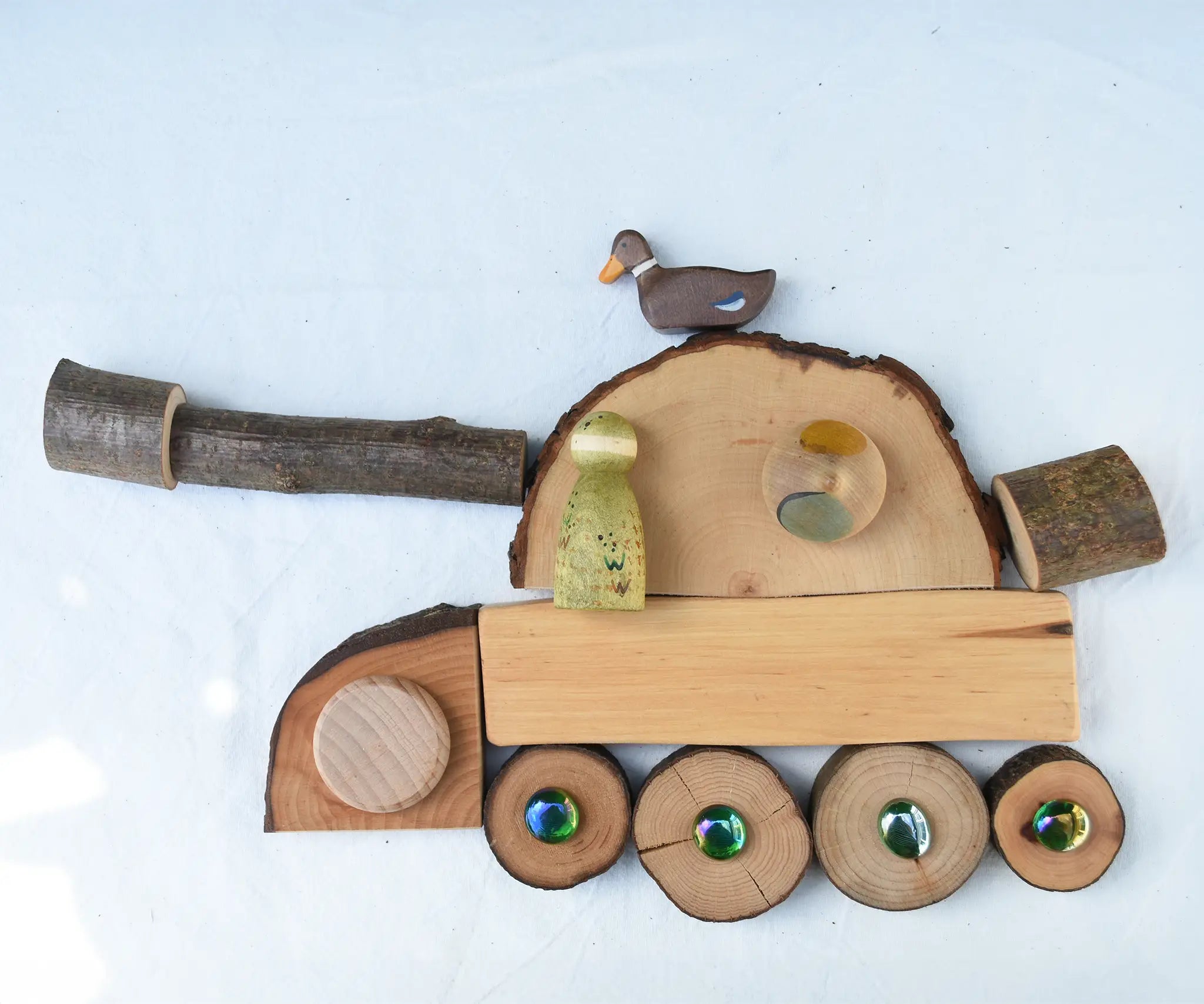 Tank flatlay created using pieces from the Magic Wood Eco Blocks Big Box 70 piece set. Decorated with flat marbles, Nins,  Holztiger duck and Grapat pieces.