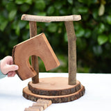 Child placing the door cutout log piece from the Magic Wood Eco Blocks Big Box 70 piece set in a stack. 
