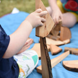 Child stacking pieces from the Magic Wood Eco Blocks Big Box 70 piece set.