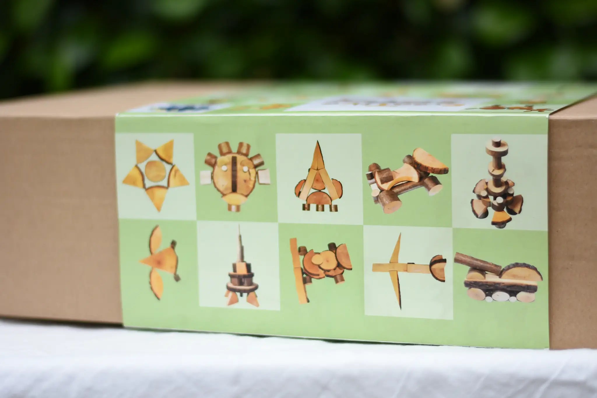 Side of box of the Magic Wood Eco Blocks Big Box 70 piece set showing some build and play ideas. 