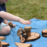Child playing with pieces from the Magic Wood Eco Blocks Big Box 70 piece set stacking them on top of each other.