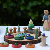 Small world play scene using the log slice pieces from the Magic Wood Eco Blocks Big Box 70 piece set as a base.