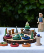 Small world play scene using the log slice pieces from the Magic Wood Eco Blocks Big Box 70 piece set as a base.