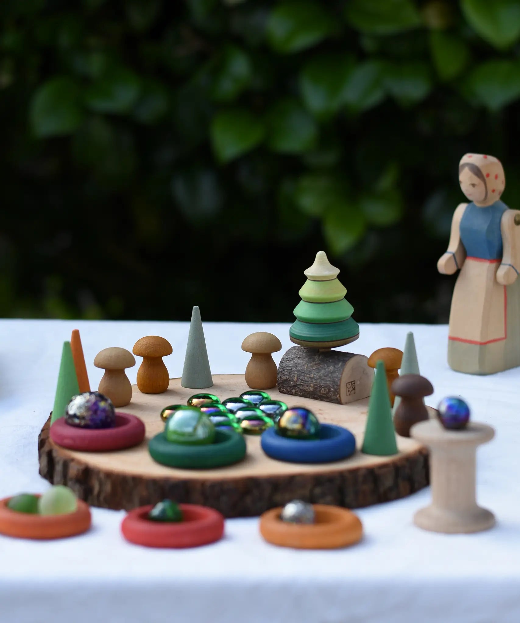 Small world play scene using the log slice pieces from the Magic Wood Eco Blocks Big Box 70 piece set as a base.