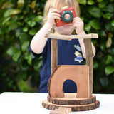 Small build created using the Magic Wood Eco Blocks Big Box 70 piece set. Child in background with a PlanToys camera.