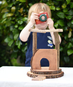 Small build created using the Magic Wood Eco Blocks Big Box 70 piece set. Child in background with a PlanToys camera.