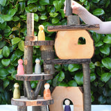 Log piece being placed at the top of a build created using the Magic Wood Eco Blocks in a 22 piece set.