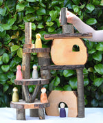 Log piece being placed at the top of a build created using the Magic Wood Eco Blocks in a 22 piece set.