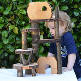 Child standing behind a build created using the Magic Wood Eco Blocks in a 22 piece set