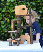 Child standing behind a build created using the Magic Wood Eco Blocks in a 22 piece set