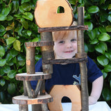 Build created using the Magic Wood Eco Blocks in a 22 piece set. Child peeping through smiling.
