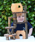 Build created using the Magic Wood Eco Blocks in a 22 piece set. Child peeping through smiling.