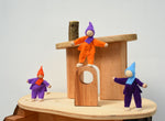 Three of the Magic Wood Felt Elves shown on a Magic Wood tree house. 