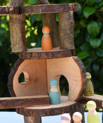Close up of Grimm;s friends peg dolls placed on a structure created using pieces from the  Magic Wood oiled ecoBlocks 36 piece set.