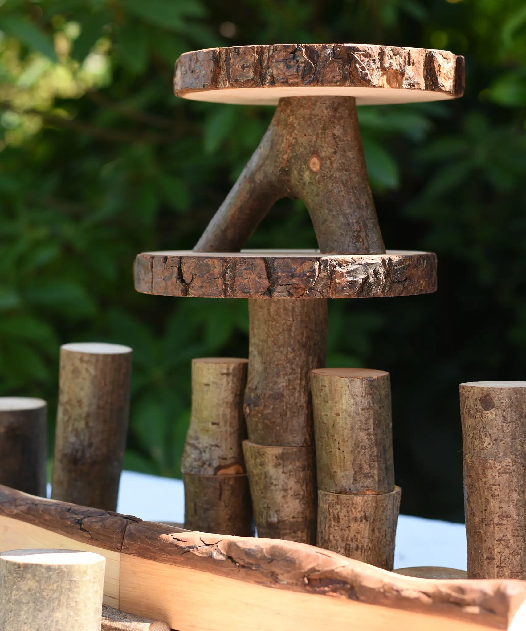 Close up of some stacked log slices and logs from the Magic Wood oiled ecoBlocks 36 piece set.