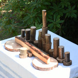  Magic Wood oiled ecoBlocks 36 piece set, with pieces lines up on a table outdoors.