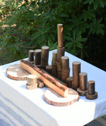  Magic Wood oiled ecoBlocks 36 piece set, with pieces lines up on a table outdoors.