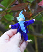 A blue Magic Wood Elf shown in a persons hand to show scale. 